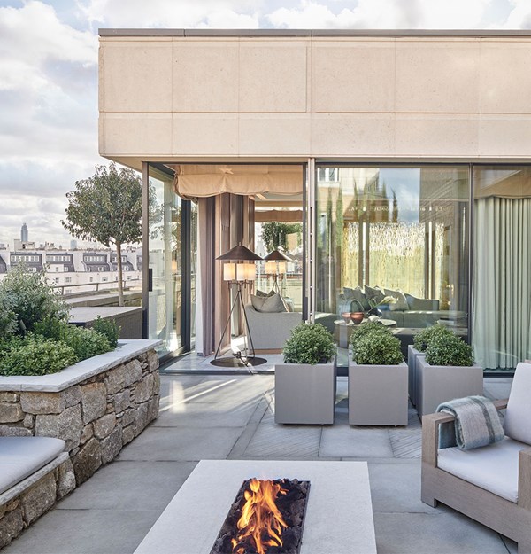 Suite at The Berkeley's terrace with grey outdoor furniture and fire