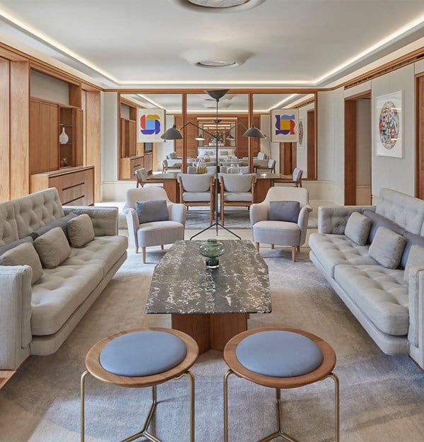 View of living room area in suite with two sofas facing one another and a marble coffee table between them