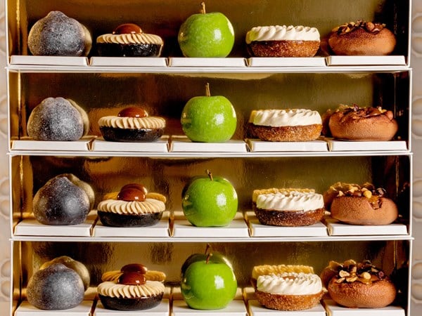 Four rows of intricately decorated autumnal pastries featuring rich textures.