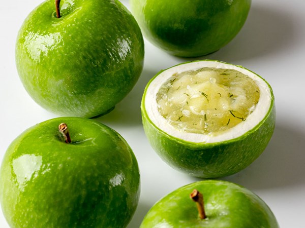 Cakes that resemble apples, including a cross-section of one to show the inside of the cake.