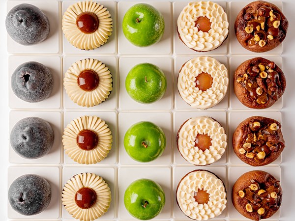 Cakes that resemble apples, including a cross-section of one to show the inside of the cake.