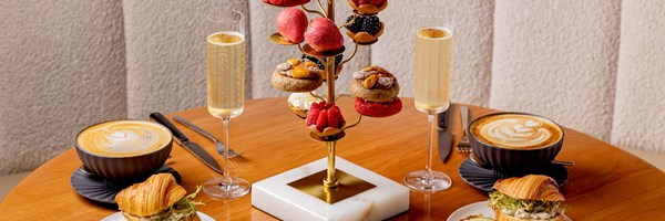 Cedric Grolet's Goutea, featuring 2 croissant sandwiches, 2 glasses of champagne and tiers of Cedric Grolet patisserie